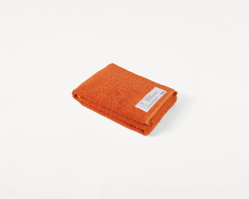 https://framacph.com/cdn/shop/products/2933_f85ec6eb10-frama-heavy-towel-burn-orange-hand-towel-packshot-1-original_800x.jpg?v=1655324384